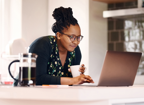 WCB Online account, woman at computer smiling