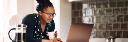 WCB Online account, woman at computer smiling