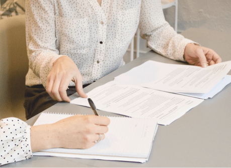 Two people signing documents