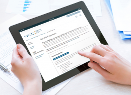 Workers can submit claim expenses online, women using WCB online services on tablet